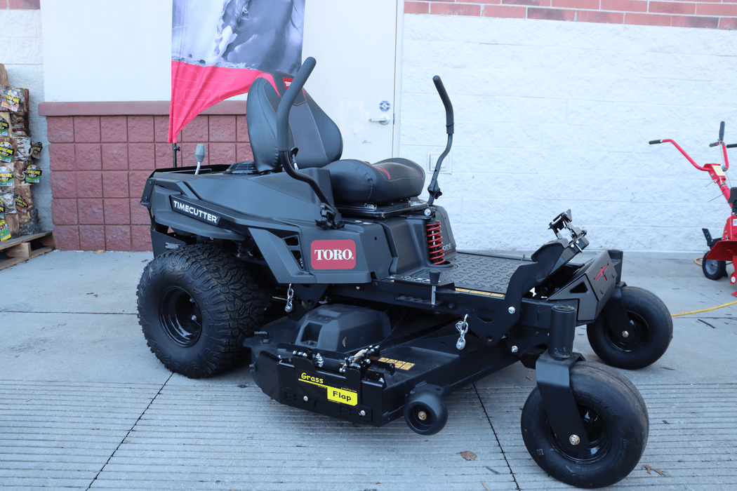 Close-up of GrassFlap™ brand steel chute blocker plate with SED pedal for Toro TimeCutter zero turn mower