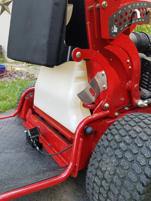 Close-up of GrassFlap™ SE pedal installed on Toro GrandStand zero turn mower, showing foot-operated control for chute blocker.